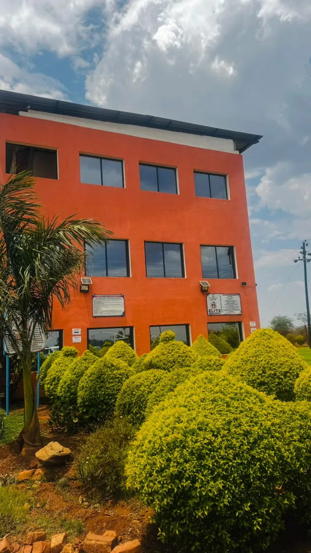 The orange administration block with the Elite High School sign