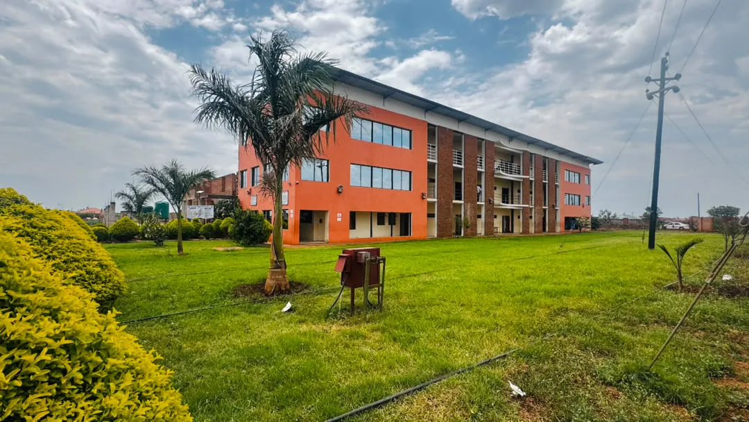 The Elite High School classroom block, lawns and palm trees in Mahatshula North