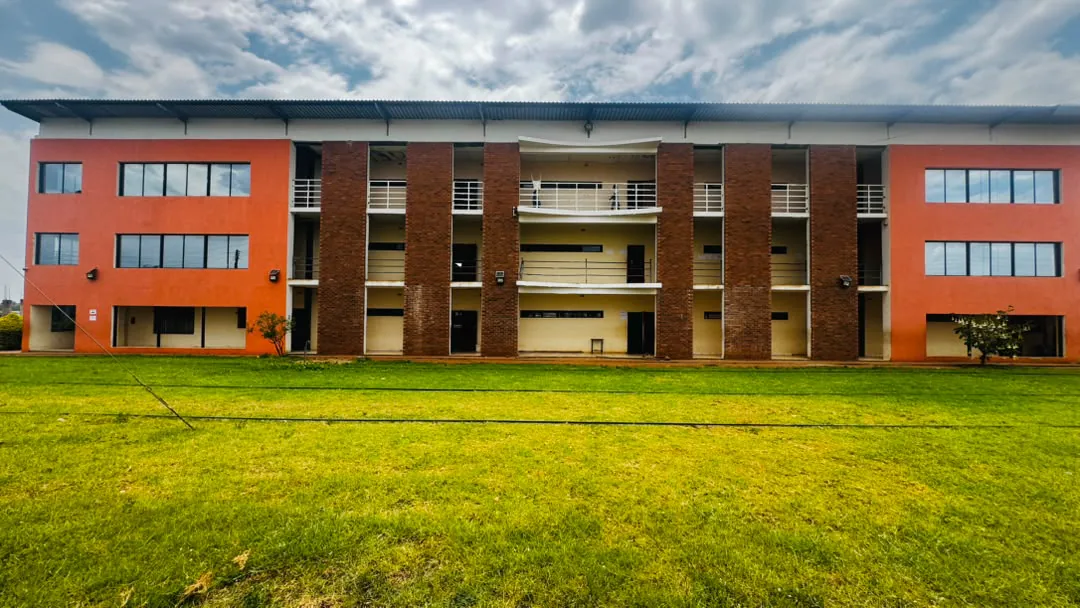Front of the three-storey classroom block across the lawn